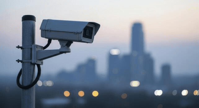 Surveillance camera overlooking a city skyline at dusk
